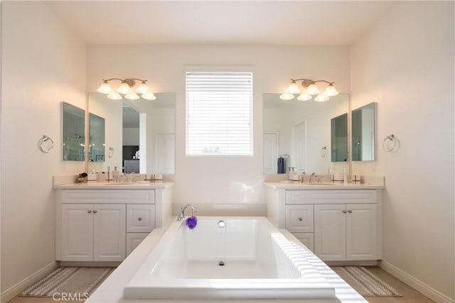 bathroom with vanity and a washtub