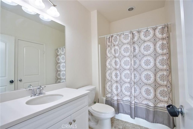 full bathroom featuring vanity, toilet, tile patterned flooring, and shower / bath combo