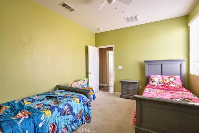 bedroom with multiple windows, light colored carpet, and ceiling fan