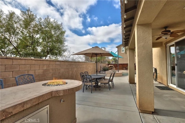 view of patio / terrace featuring ceiling fan and an outdoor fire pit