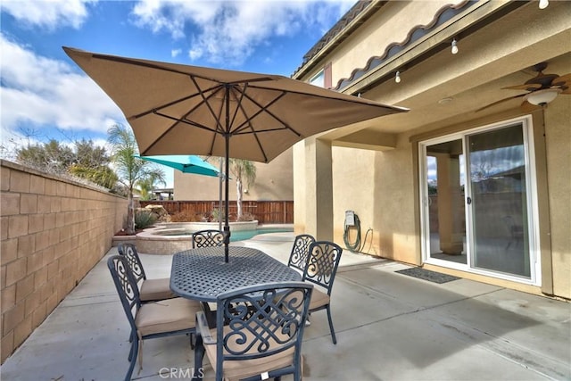 view of patio featuring an in ground hot tub and ceiling fan