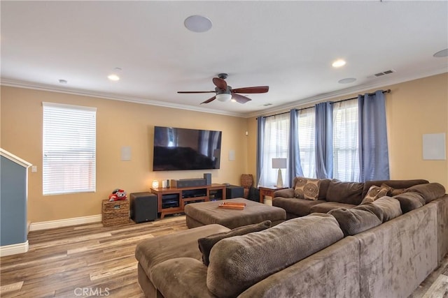 living room featuring hardwood / wood-style floors, crown molding, and ceiling fan