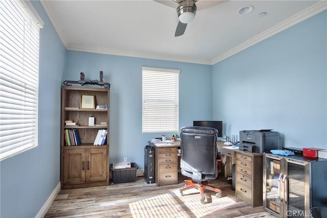 home office with ceiling fan, ornamental molding, and light wood-type flooring