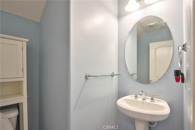 bathroom featuring sink and toilet