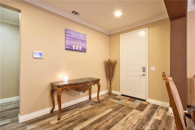 entrance foyer with hardwood / wood-style flooring and ornamental molding