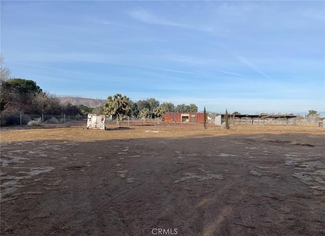 view of yard featuring a rural view and a mountain view