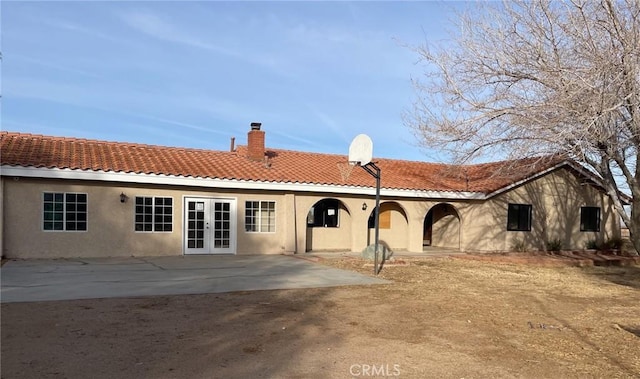 back of property with a patio and french doors