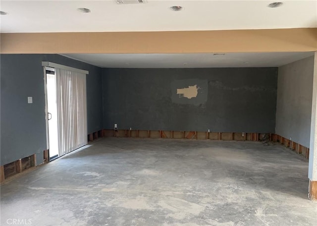 unfurnished room with concrete flooring