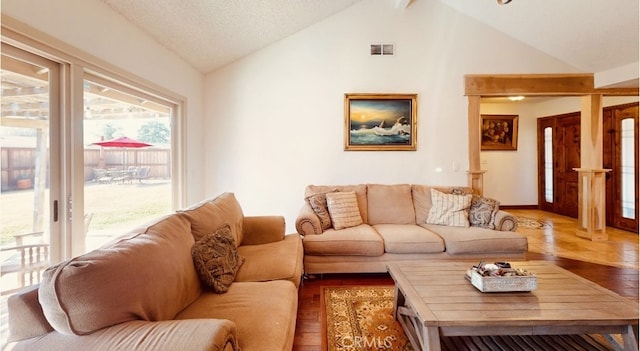 living room with hardwood / wood-style flooring and vaulted ceiling