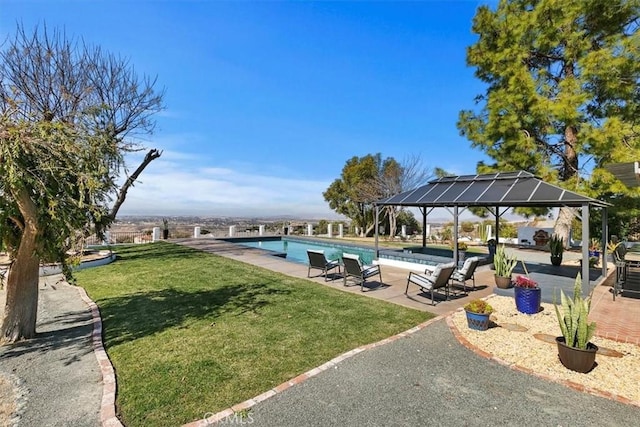 view of pool featuring a yard, a gazebo, and a patio