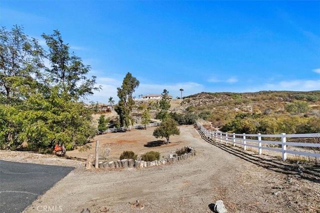 view of yard with a rural view