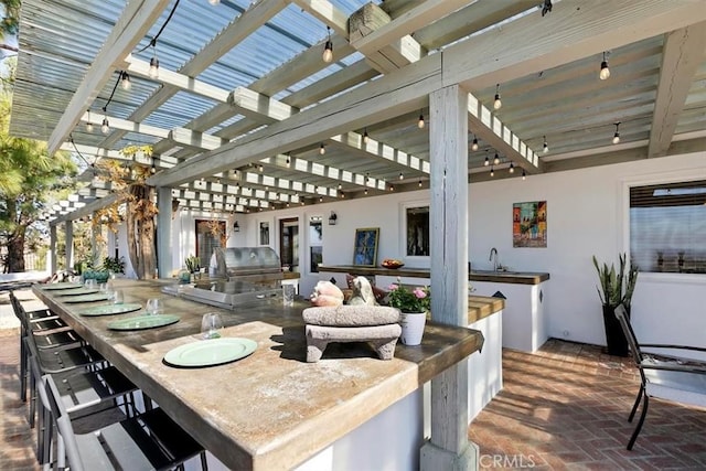 view of patio / terrace featuring area for grilling, a grill, a pergola, and sink