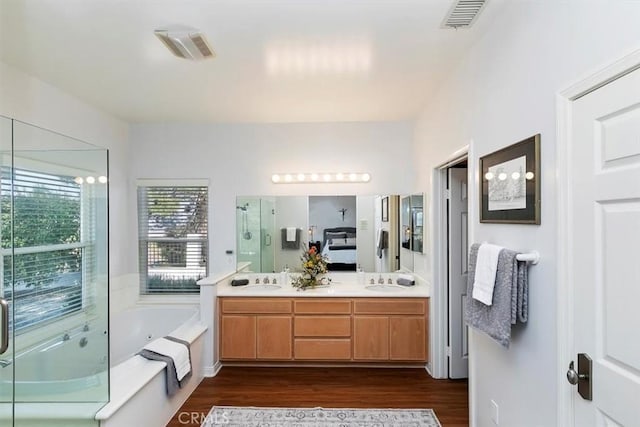 bathroom featuring vanity, hardwood / wood-style flooring, and independent shower and bath