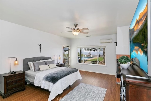 bedroom featuring ceiling fan, a wall mounted air conditioner, and dark hardwood / wood-style flooring