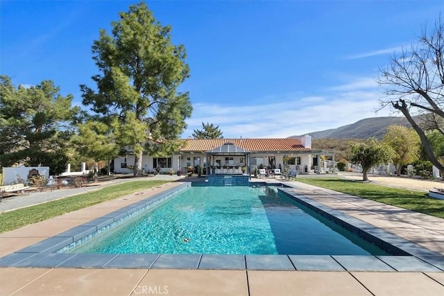 view of pool featuring a mountain view and a patio