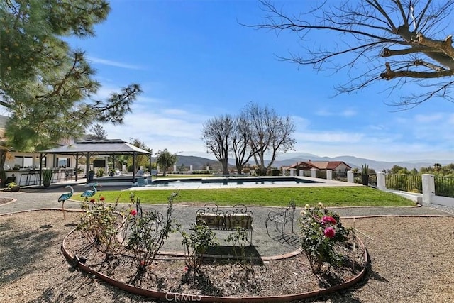 surrounding community featuring a gazebo, a swimming pool, and a mountain view