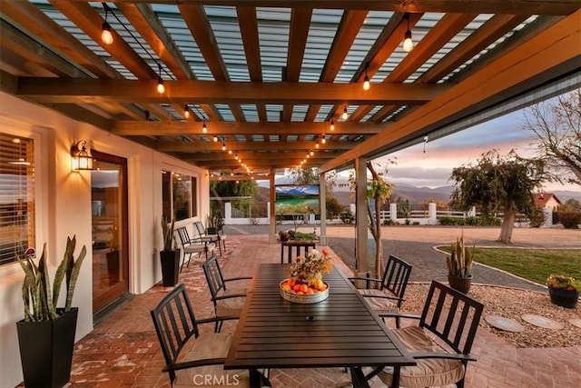 patio terrace at dusk featuring a pergola