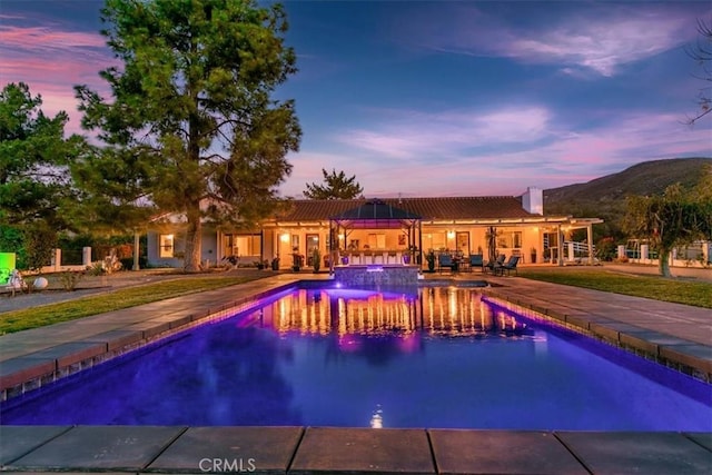 view of swimming pool with a pool with connected hot tub and a patio area