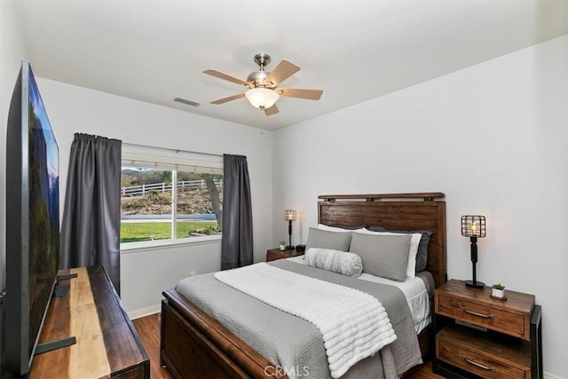 bedroom featuring dark hardwood / wood-style floors and ceiling fan