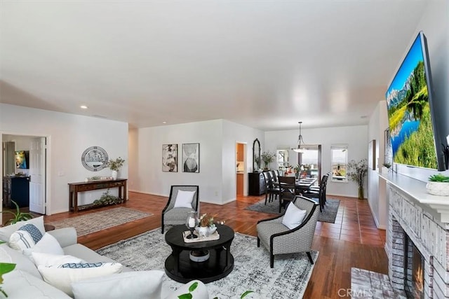 living room featuring wood-type flooring and a fireplace