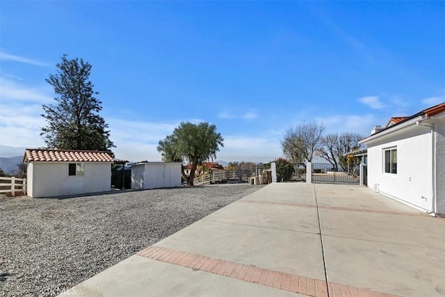 view of yard featuring a patio area and a storage unit