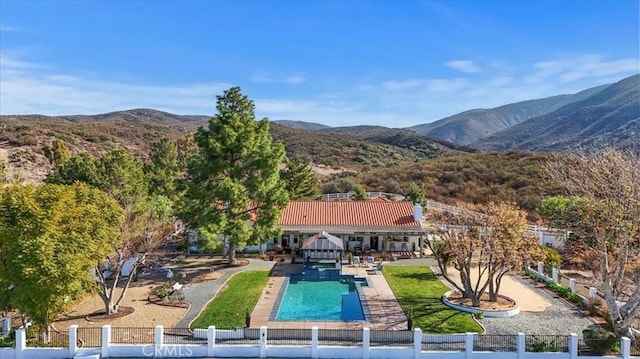 exterior space featuring a mountain view and a patio area