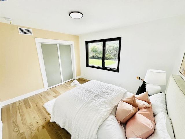 bedroom featuring a closet and light hardwood / wood-style flooring