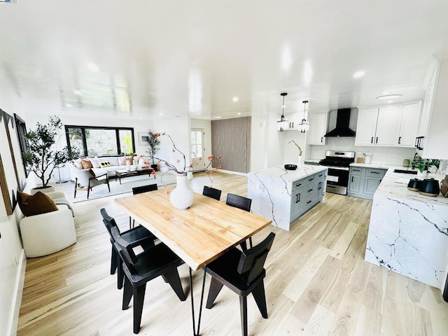 dining space featuring sink and light hardwood / wood-style floors