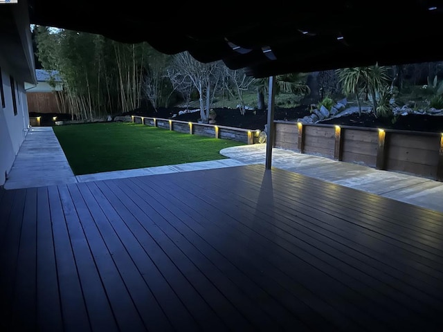 wooden terrace featuring a yard