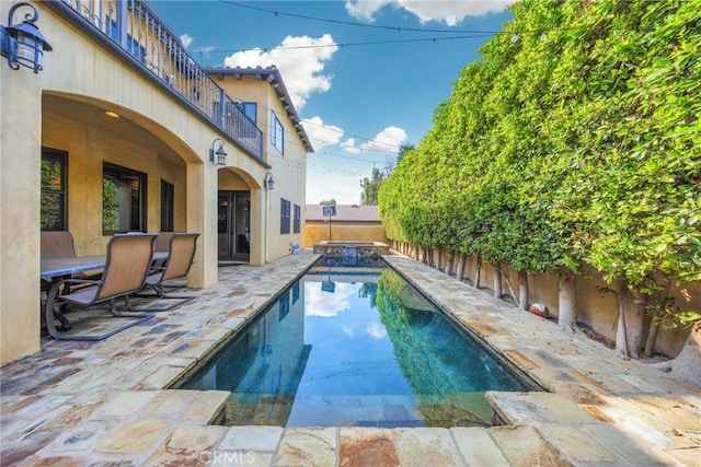 view of swimming pool with a patio