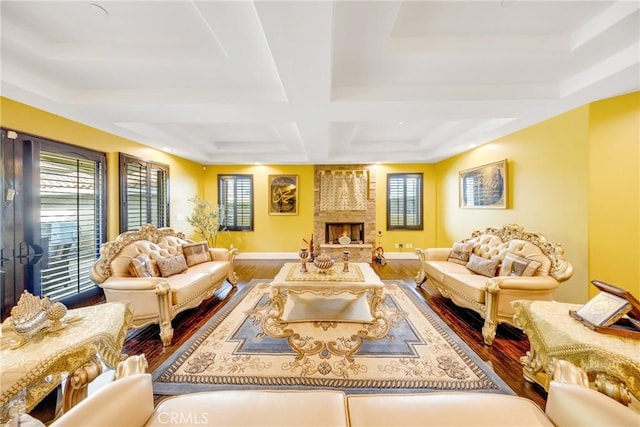 living room featuring coffered ceiling, hardwood / wood-style floors, and a fireplace