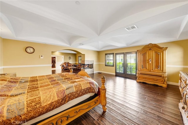 bedroom with access to exterior, dark wood-type flooring, and french doors