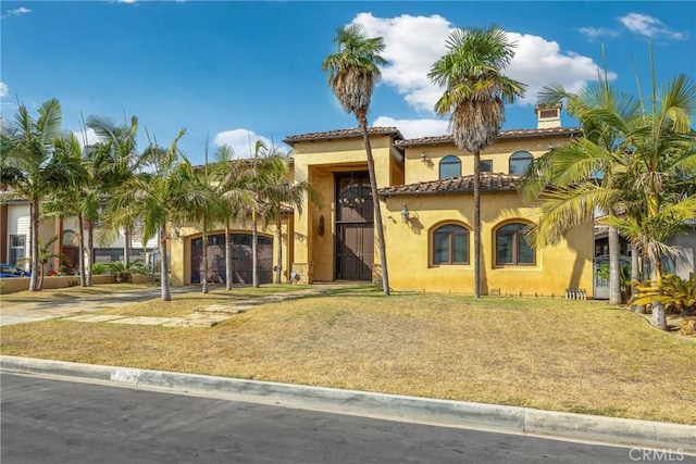 mediterranean / spanish-style home with a front yard