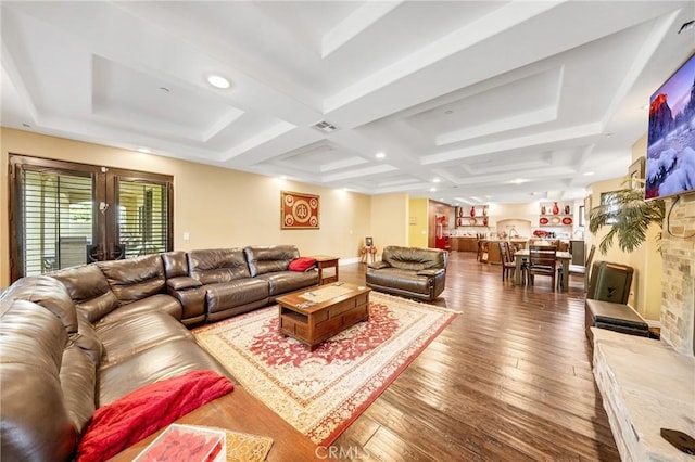 living room featuring coffered ceiling and hardwood / wood-style floors