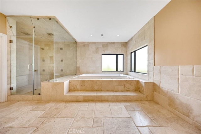 bathroom with plus walk in shower and tile walls