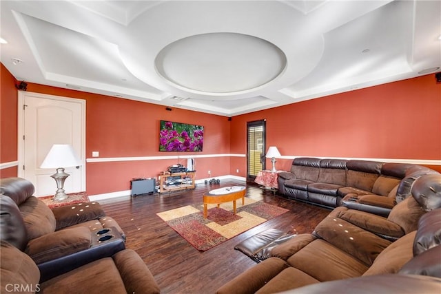 living room featuring a raised ceiling and dark hardwood / wood-style floors