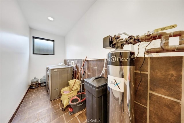 clothes washing area with separate washer and dryer