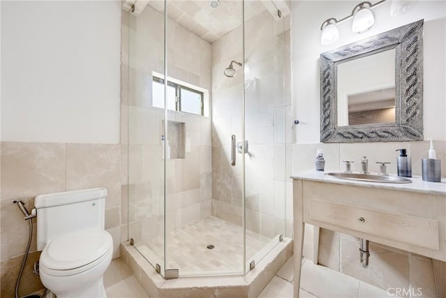 bathroom with tile walls, sink, a shower with door, and toilet