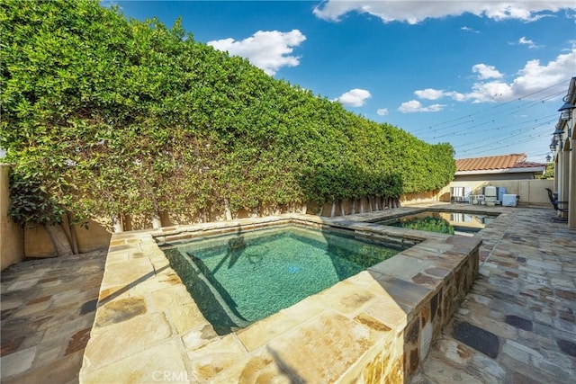 view of swimming pool with a patio area