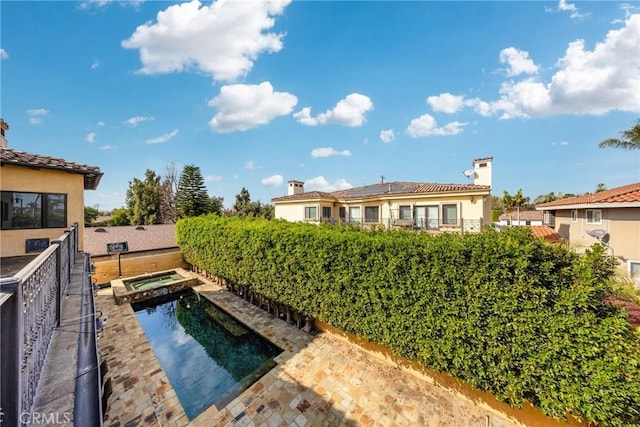 view of pool featuring an in ground hot tub