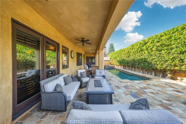 view of patio / terrace featuring ceiling fan, an outdoor hangout area, and a fenced in pool