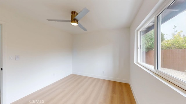 spare room featuring light hardwood / wood-style floors and ceiling fan