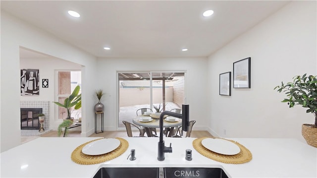 dining room featuring a tiled fireplace