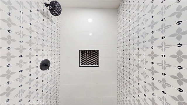 bathroom with a tile shower