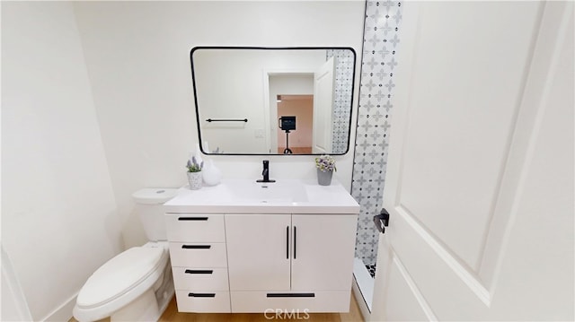 bathroom featuring vanity and toilet