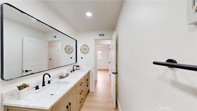 bathroom featuring vanity and wood-type flooring