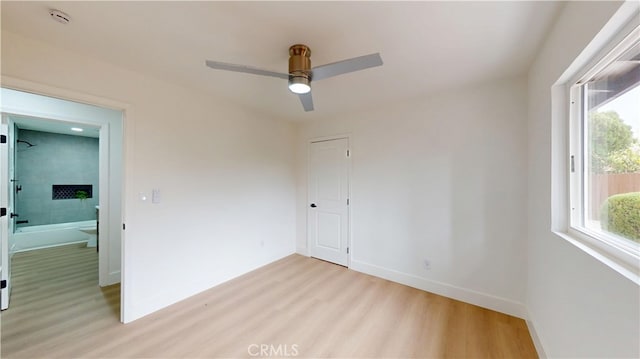 unfurnished room featuring ceiling fan and light hardwood / wood-style floors