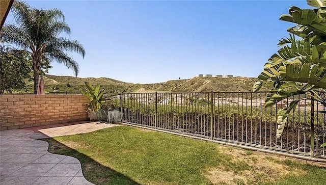 view of yard with a mountain view and a patio area