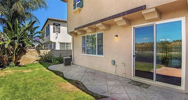 exterior space with a yard, central AC unit, and a patio area