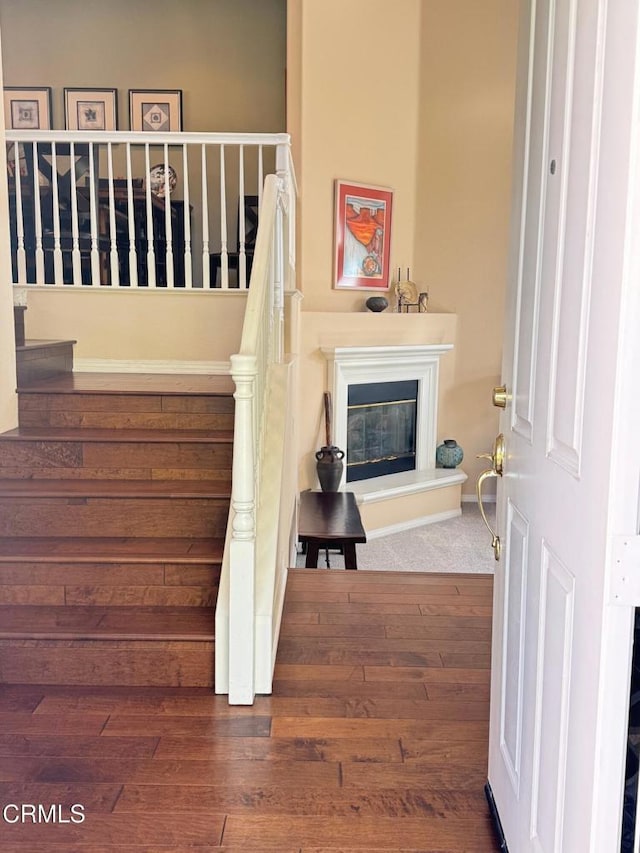 stairs featuring hardwood / wood-style flooring